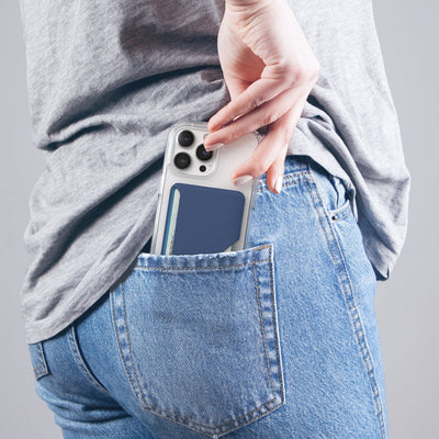 Lifestyle photo of a woman pulling an iPhone from her back pocket with Wallet for MagSafe with ClickLock attached to the phone case.#color_coastal-blue-space-blue