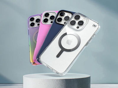 iPhone 16 phones are in various colors and designs of Speck cases and fanned out over a white pedestal