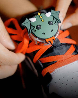 Close-up of a child's shoe with Blaze the dragon Tagimals AirTag carrier by Speck attached.