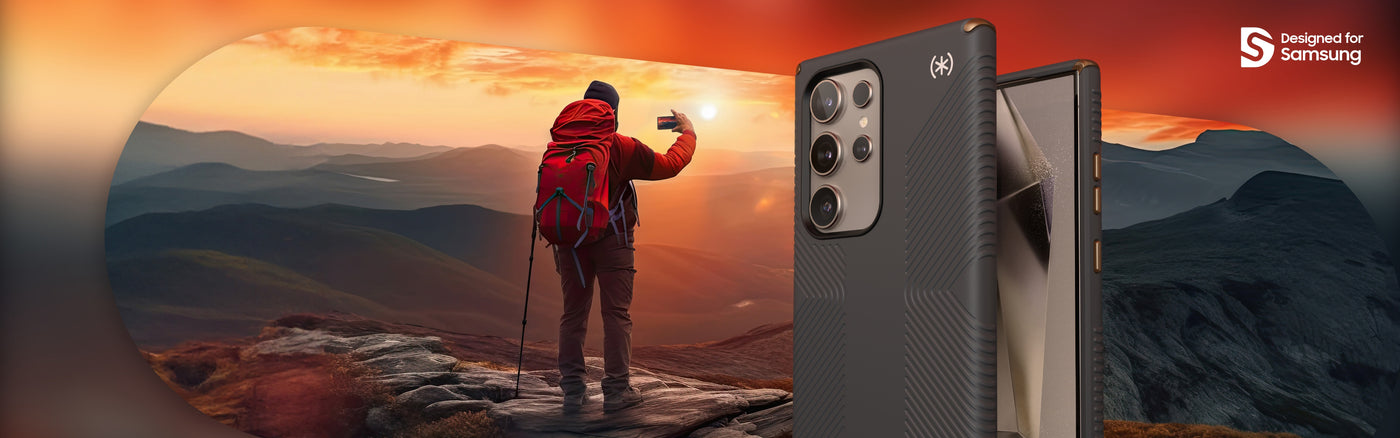 A hiker on a mountain takes a picture of a sunset with a smartphone, a Samsung Galaxy S24 Ultra in a Presidio2 Grip case by Speck is in the foreground