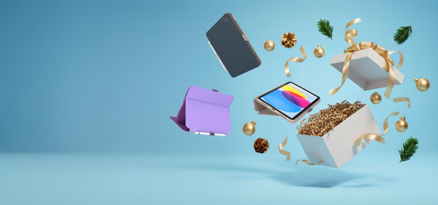 Three iPads in Speck cases fly out of a Christmas box along with ornaments and ribbon