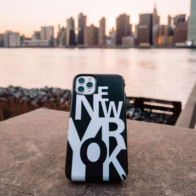 New York phone case on an iPhone with New York skyline in the background