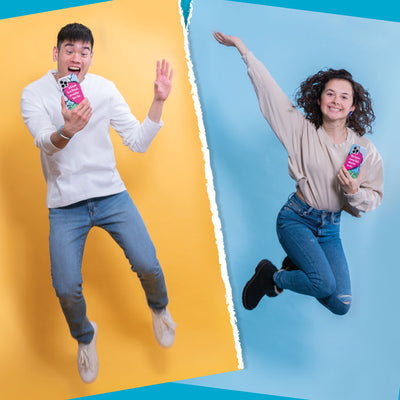 A young man and young woman jumping in the air while each holding separate sides of the Presidio Edition: Friends Forever Collection case