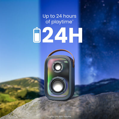 Front view of speaker sitting on a rock with visible time passage in the sky behind it. Up to 24 hours of playtime (Lights OFF, 50% Volume)#color_dark-grey-chrome-tan