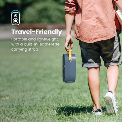 A man walking across grass carries a Gemtones Infinity speaker by the handle. Travel friendly - portable and lightweight with a built-in leatherette carrying strap#color_dark-grey-chrome-tan