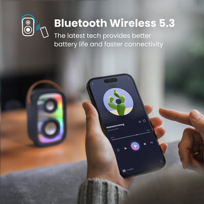 A person controls a music app on a smartphone in front of a Gemtones Infinity speaker. Bluetooth wireless 5.3 - the latest tech provides better battery life and faster connectivity#color_dark-grey-chrome-tan