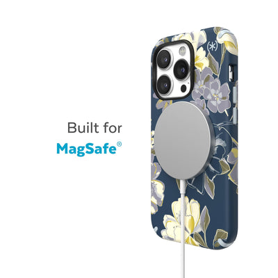 Three-quarter view of back of phone case with MagSafe charger attached - Built for MagSafe.#color_artistic-floral-tear-blue