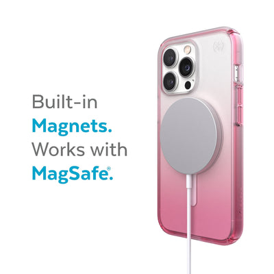 Three-quarter view of back of phone case with MagSafe charger attached - Built-in magnets. Works with MagSafe.#color_clear-cosmo-pink-fade