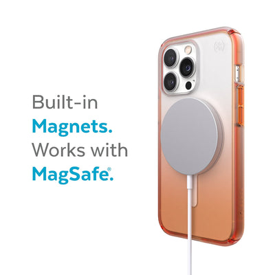 Three-quarter view of back of phone case with MagSafe charger attached - Built-in magnets. Works with MagSafe.#color_clear-orange-soda-fade