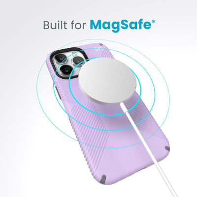 A case with phone inside with camera facing up and MagSafe wireless charger hovering above with concentric circles eminating from charger to signify power transfer. Text in image reads built for MagSafe.#color_spring-purple-cloudy-grey