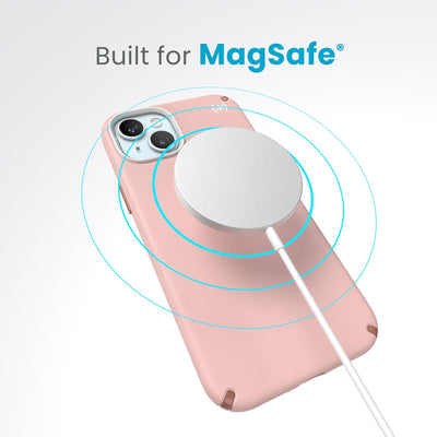 A case with phone inside with camera facing up and MagSafe wireless charger hovering above with concentric circles eminating from charger to signify power transfer. Text in image reads built for MagSafe.#color_dahlia-pink-rose-copper