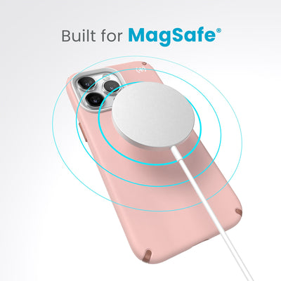 A case with phone inside with camera facing up and MagSafe wireless charger hovering above with concentric circles eminating from charger to signify power transfer. Text in image reads built for MagSafe.#color_dahlia-pink-rose-copper