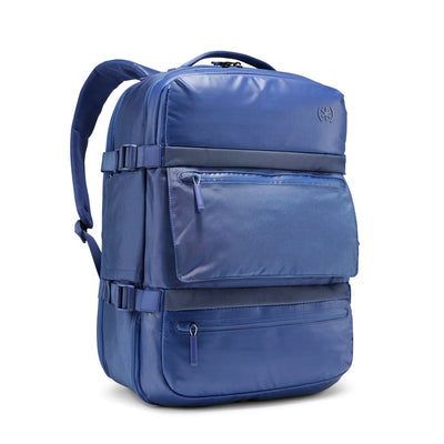 Three-quarter front view of Speck Travel Backpack in Macaw Blue.#color_macaw-blue