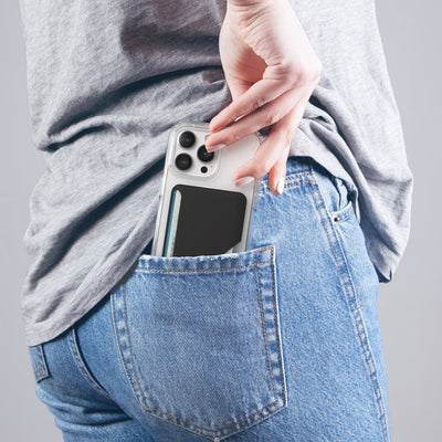 Lifestyle photo of a woman pulling an iPhone from her back pocket with Wallet for MagSafe with ClickLock attached to the phone case.#color_black