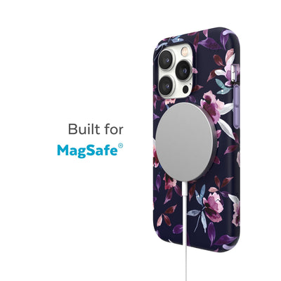Three-quarter view of back of phone case with MagSafe charger attached - Built for MagSafe.#color_spring-purple-violet-floral